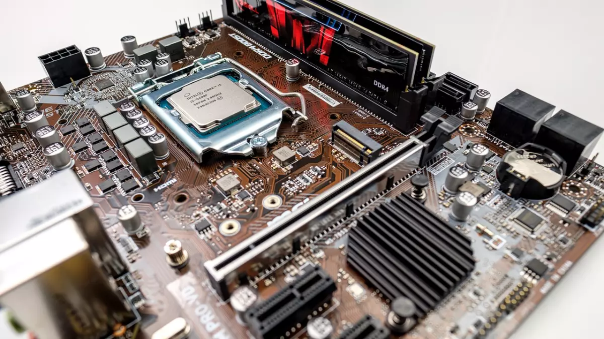 A close-up shot of a computer motherboard with components like the CPU, RAM, and other connectors. The motherboard is a key component in any computer system, providing connectivity and communication pathways for all the other components.