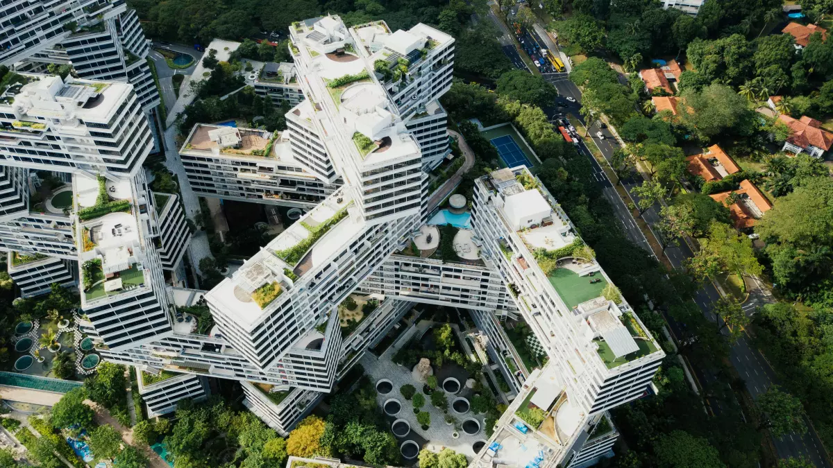 Aerial view of a futuristic building with multiple levels and balconies.