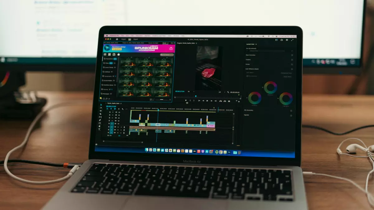 A laptop with an open window showing a software interface, possibly an Adobe program like Photoshop, on a wooden table.