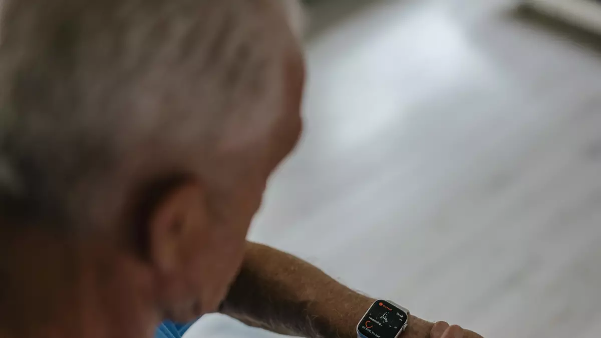 A man wearing a smartwatch on his wrist, viewed from above