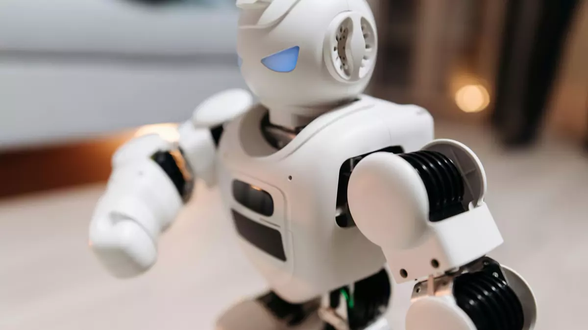 A close-up view of a white humanoid robot with black detailing, emphasizing its sleek design and articulated joints.