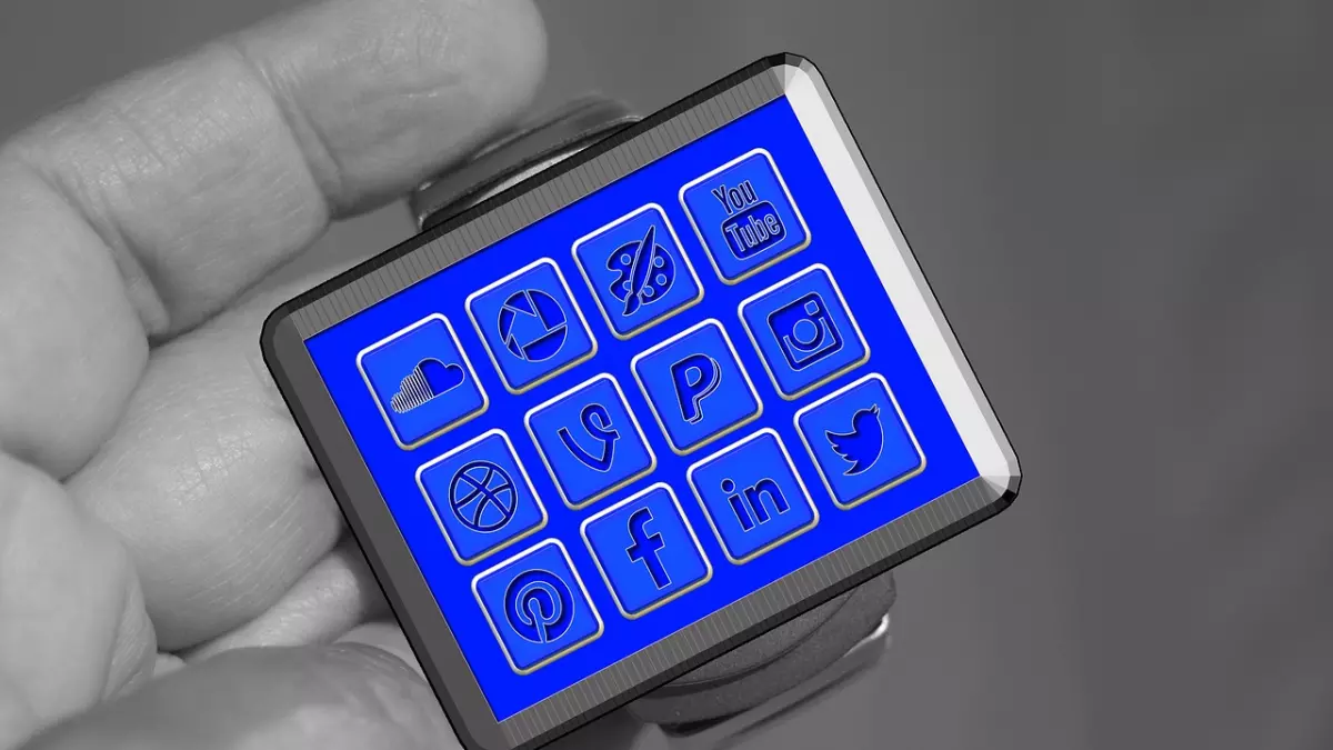 A smartwatch with a blue screen displaying various social media app icons.