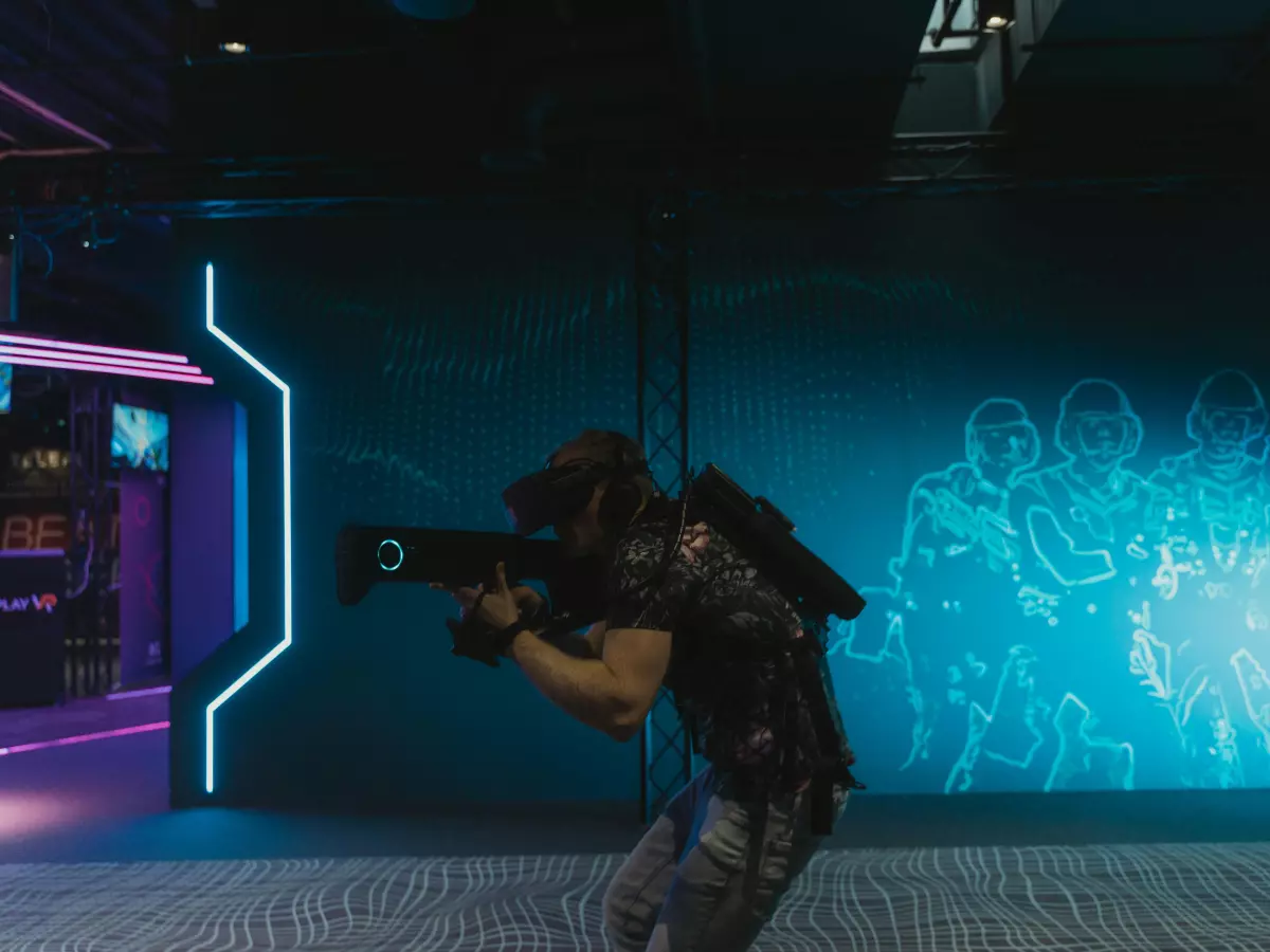 A person holding a weapon in a sci-fi video game environment, showcasing a futuristic world