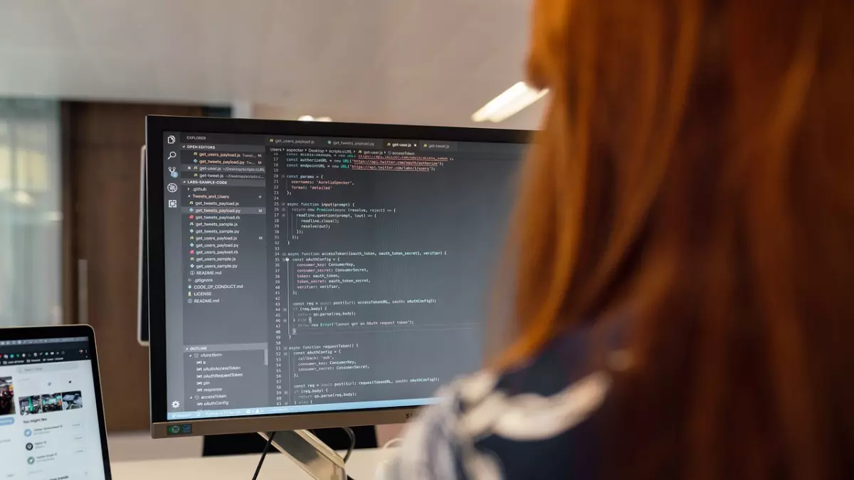 A woman coding on a computer.