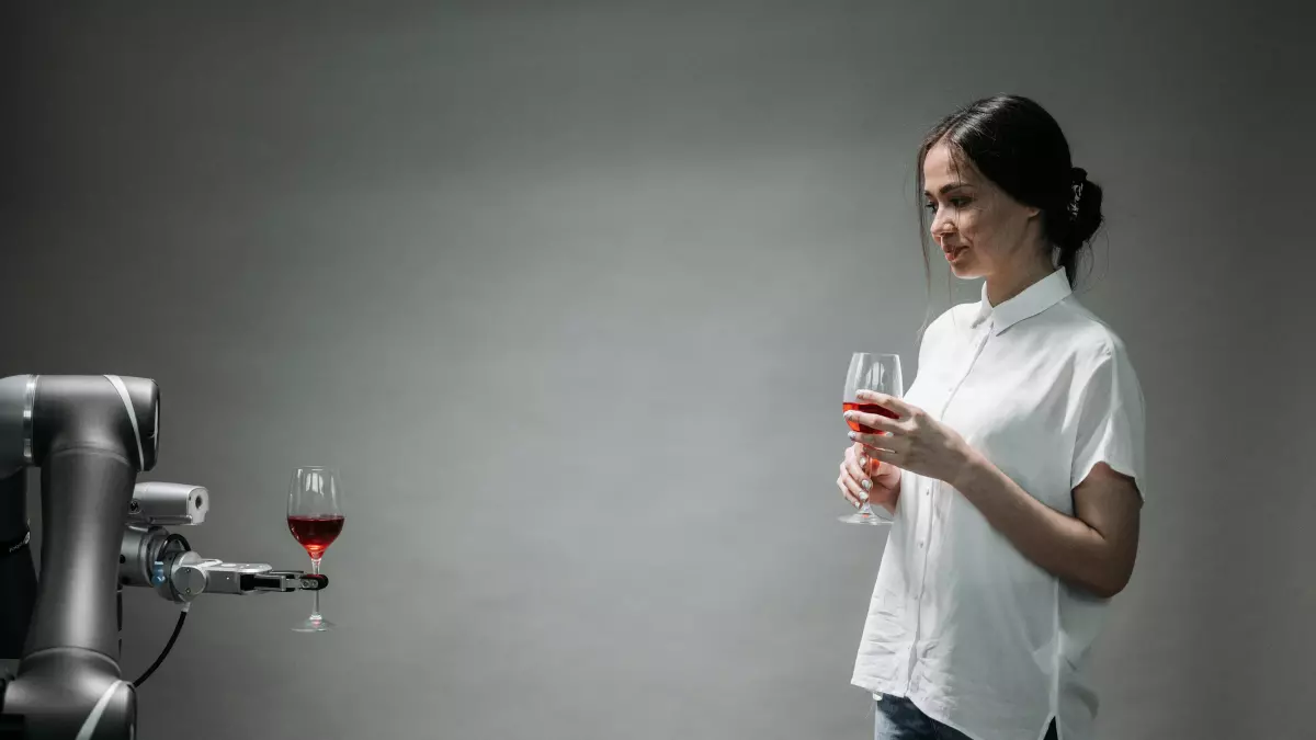 A robotic arm pouring wine into a glass held by a woman, showcasing precise movement and control.